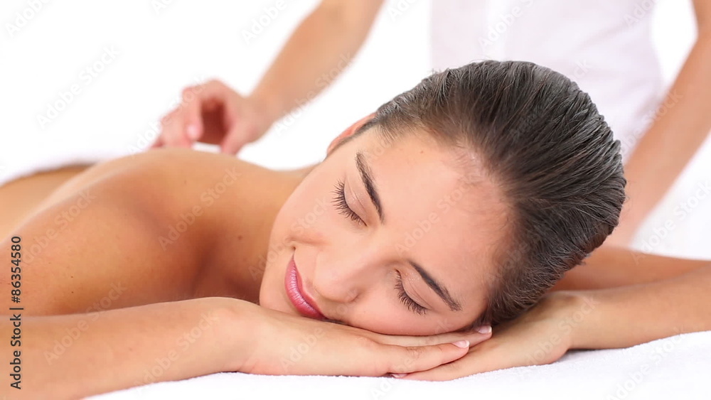 Pretty woman enjoying a hot stone massage Pretty woman enjoying a hot stone massage