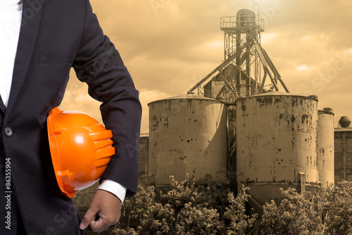 engineer holding orange helmet for workers security on contructi photo