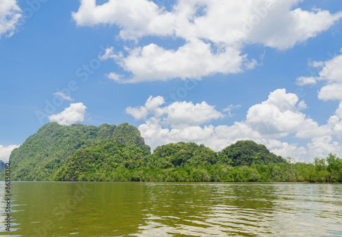 Mountain forest and sea water on White cloud on blue sky