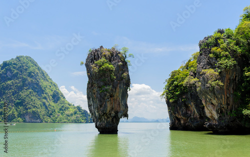 Rock hill and tree on green sea water © TinPong