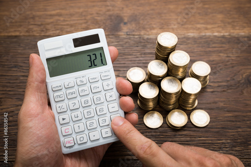 Businessman Calculating Coins