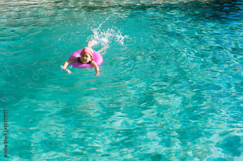 Little girl swim in the pool