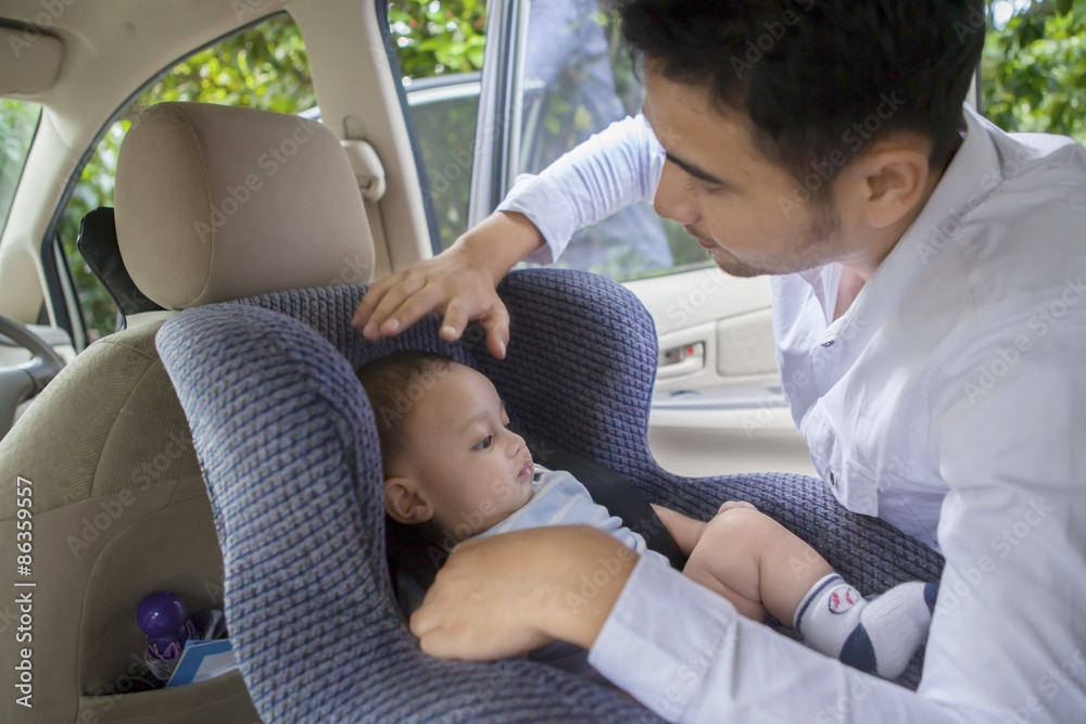Father putting his baby on the car seat Stock Photo Adobe Stock