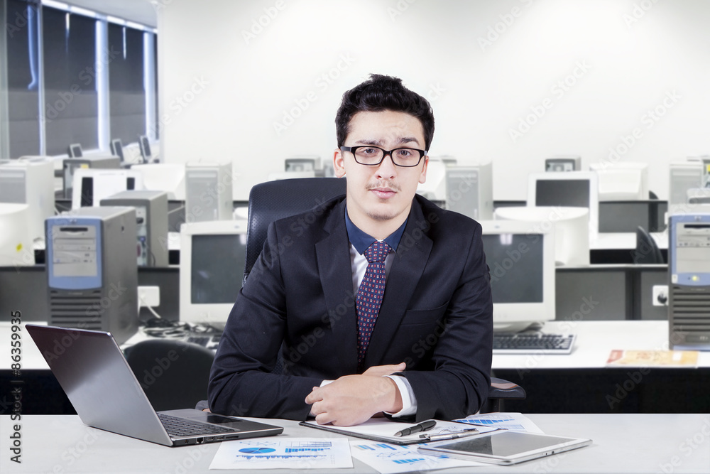 Male manager with formal suit at workplace