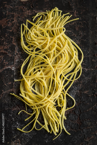 raw homemade pasta on a dark vintage surface