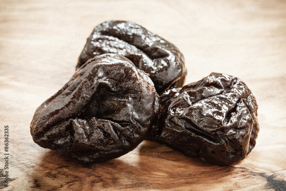dried plums prunes on wooden table dried plums prunes on wooden table