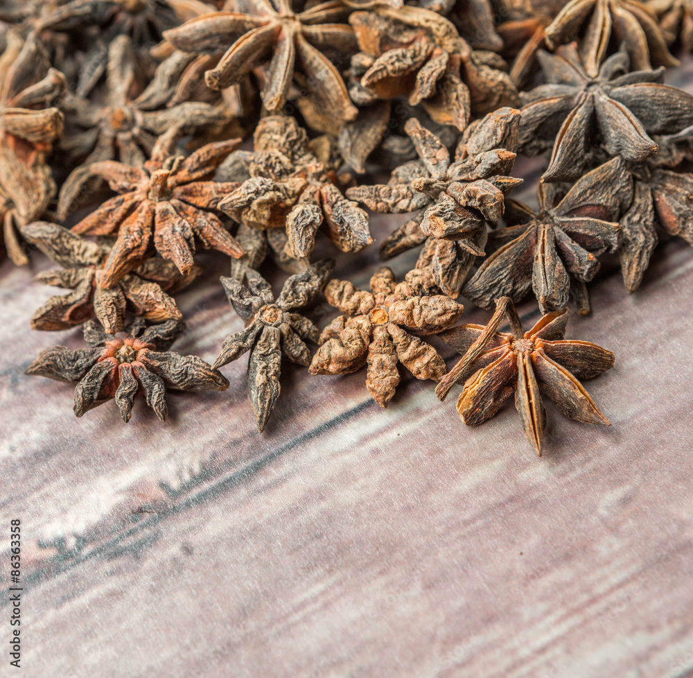 Star anise spices over weathered wooden background Star anise spices over weathered wooden background