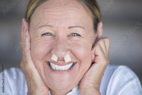 Happy smiling woman with nose plugs portrait