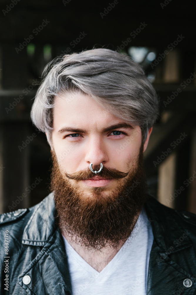 Fototapeta premium Bearded hipster with nose ring in leather jacket