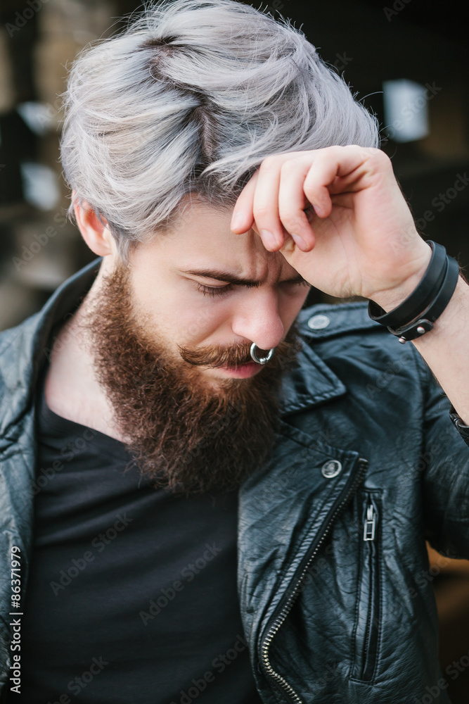 Bearded hipster with nose ring in leather jacket Bearded hipster with nose ring in leather jacket