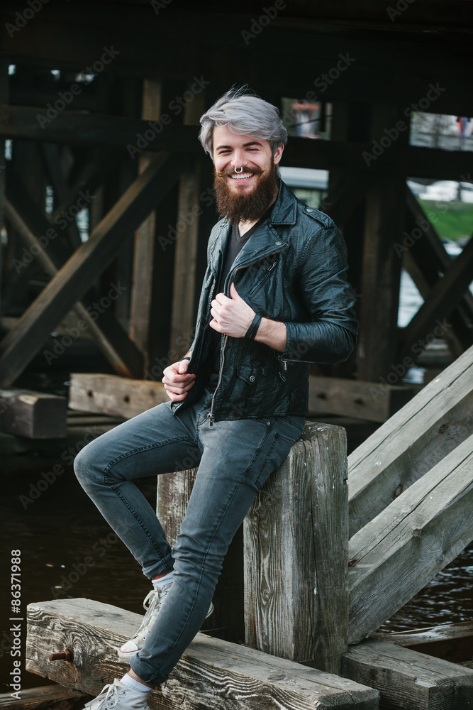 Bearded hipster with nose ring in leather jacket