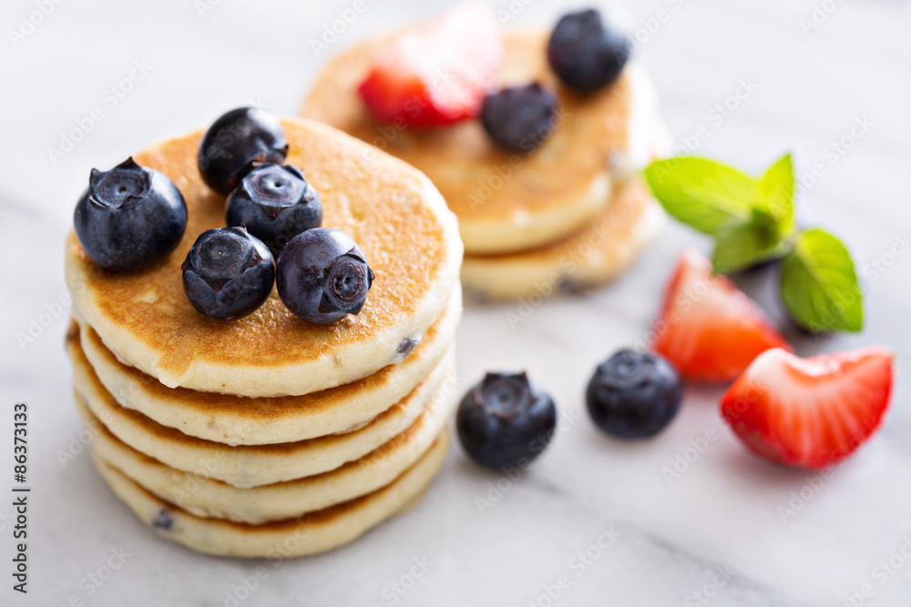 Stack of small pancakes with berries Stack of small pancakes with berries