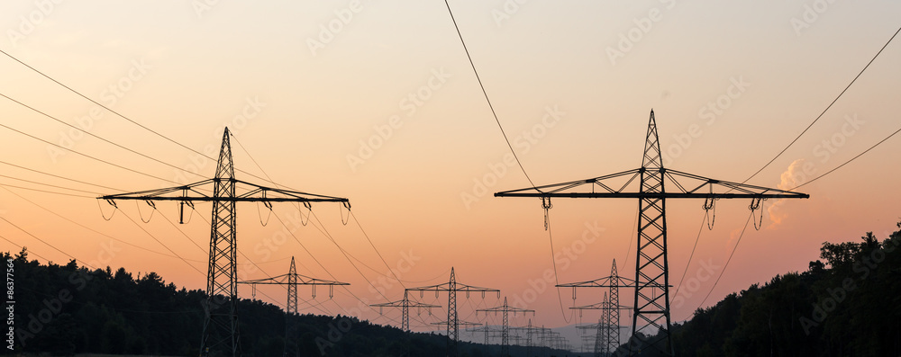 german high voltage pylons in an evenign sundown