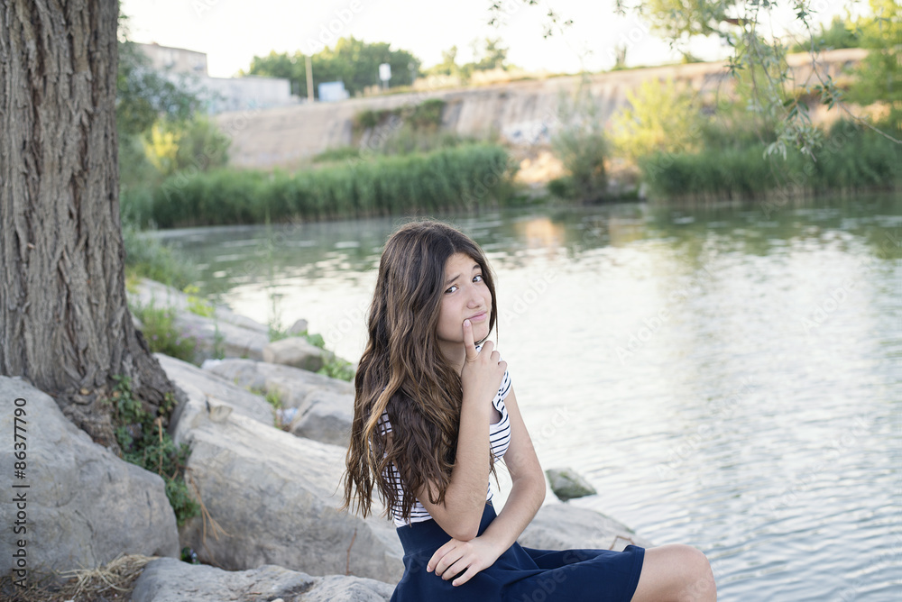 Teenage girl in the park by the river Teenage girl in the park by the river
