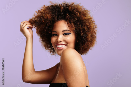 beauty latin woman with a big curly hair wears white classic jac