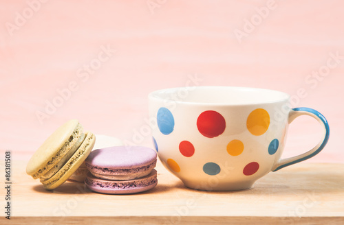 French macarons and cup on table