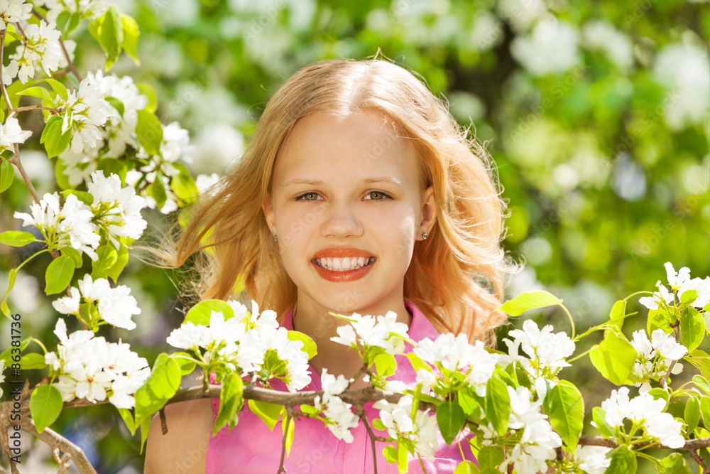 Blondie teenager girl with white pear tree flowers Blondie teenager girl with white pear tree flowers