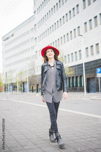 Young beautiful brunette girl walking in the city