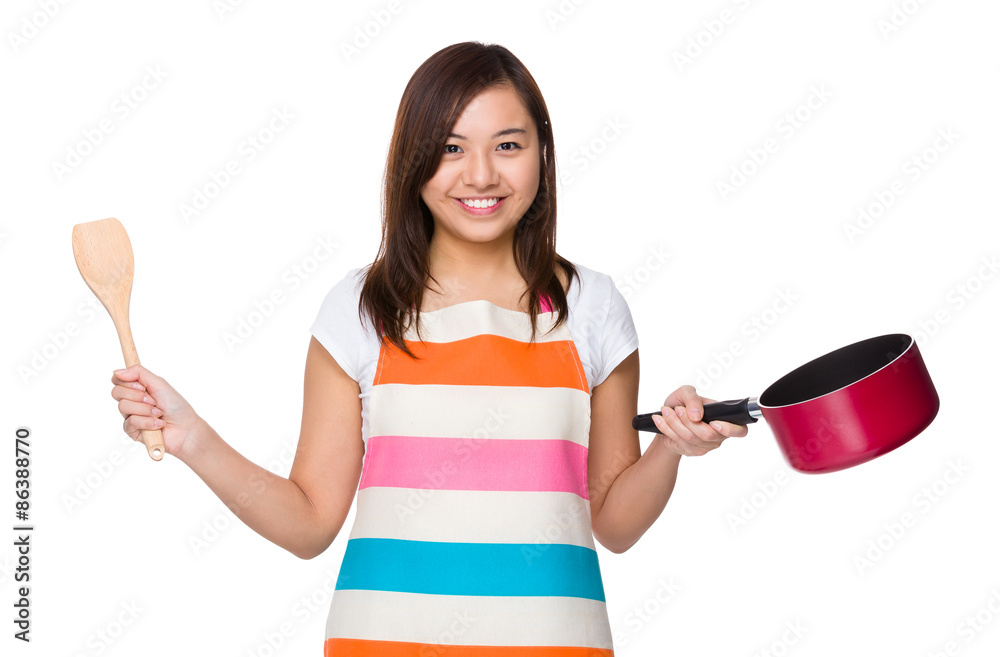 Housewife holding with wooden ladle and saucepan Housewife holding with wooden ladle and saucepan
