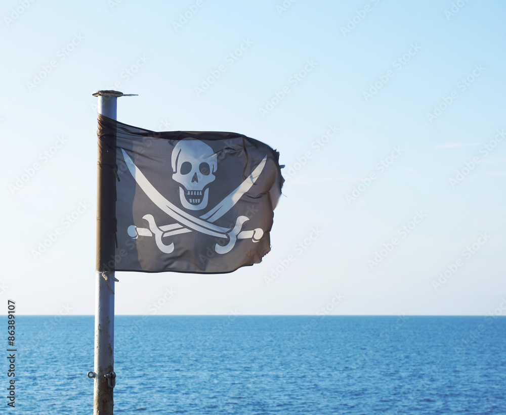 Pirate flag with skull and crossed swords fluttering in the wind