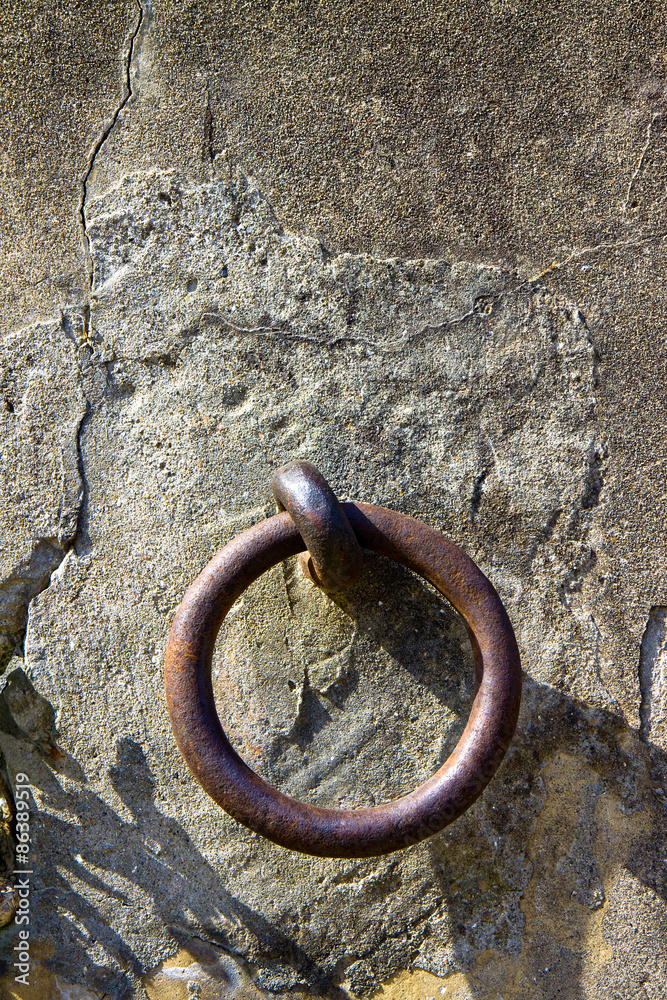 Old iron ring fixed in a plaster wall - toned image Old iron ring fixed in a plaster wall - toned image