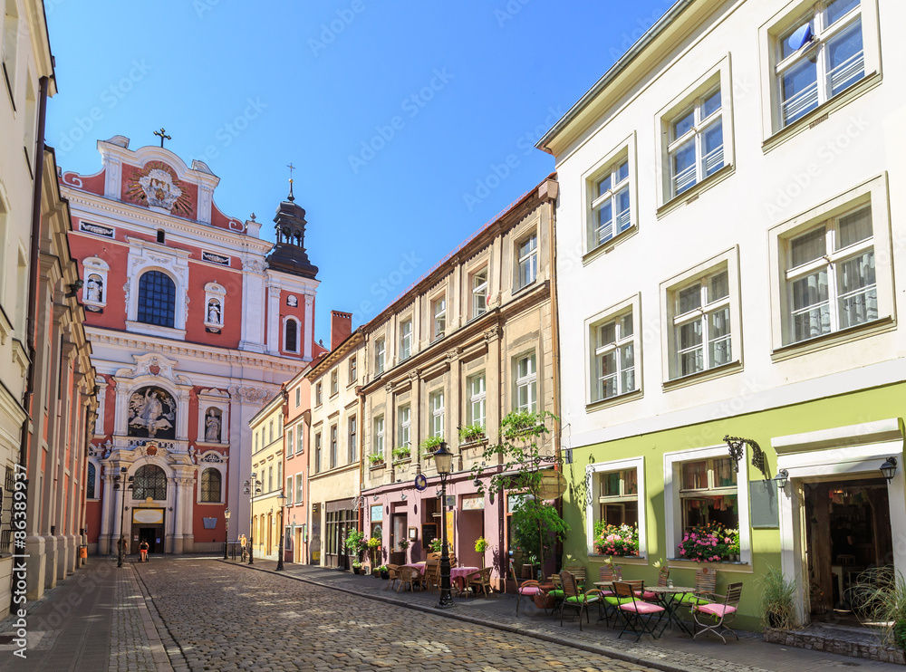 Old town in Poznan, street Świętosławska & facade of the baroque  parish church.