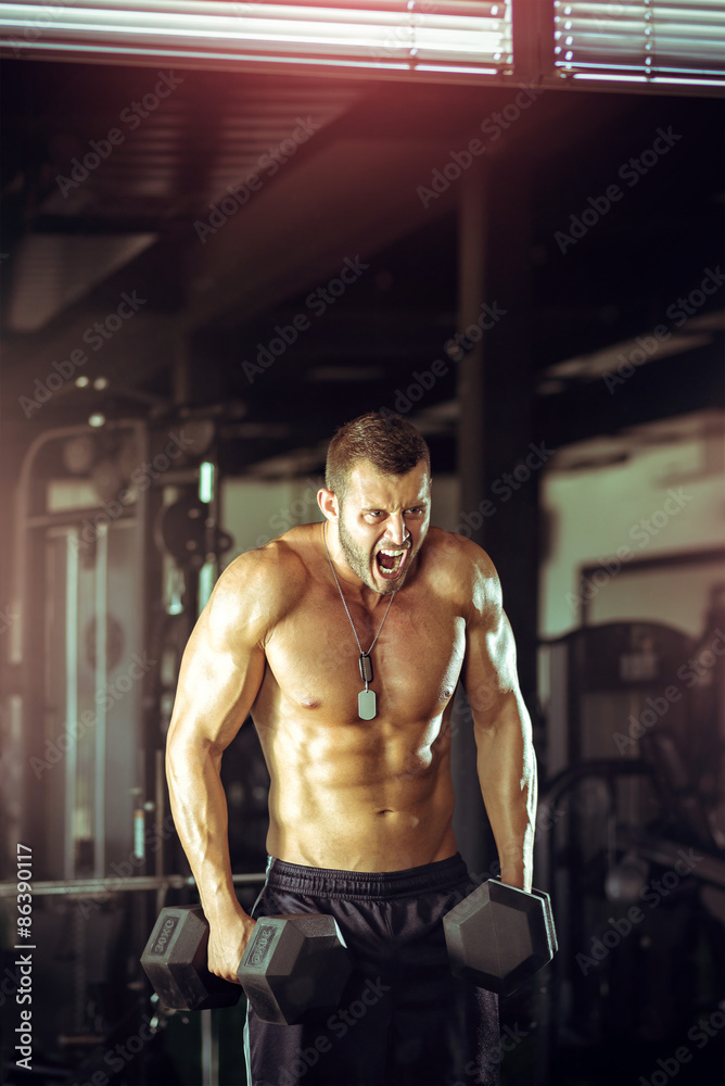 Fototapeta premium Man doing curls in gym
