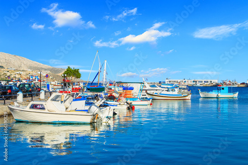 Colorful boats over clear water in peaceful Greek bay  Greece