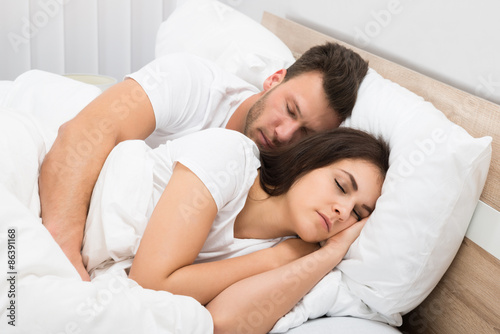 Couple Sleeping On Bed