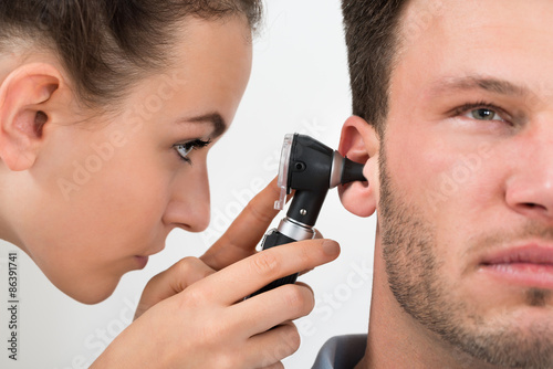 Doctor Examining Man's Ear