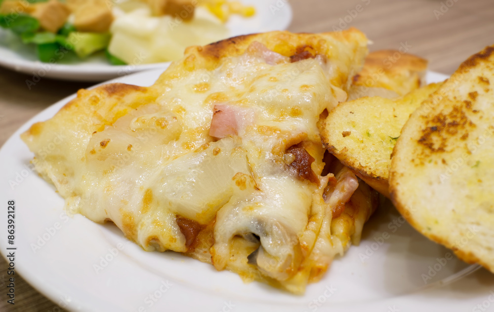 Closeup view of an appetising ham and pineapple Italian pizza wi Closeup view of an appetising ham and pineapple Italian pizza wi