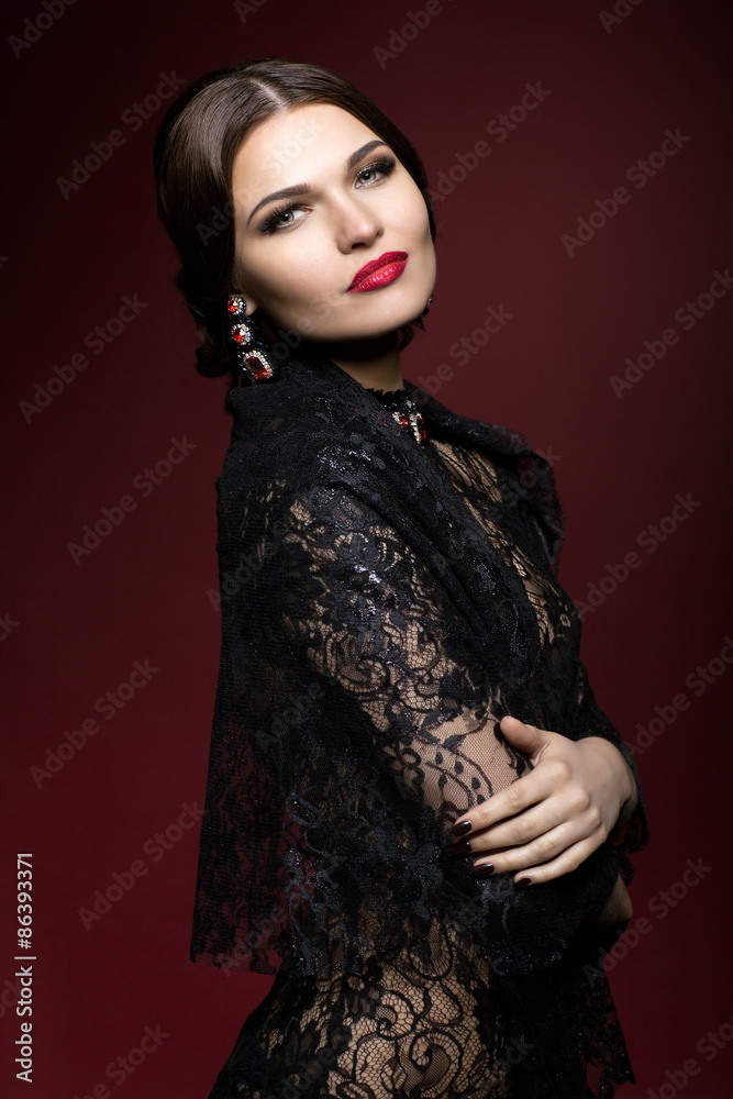 Young beautiful woman in black dress on marsala color background