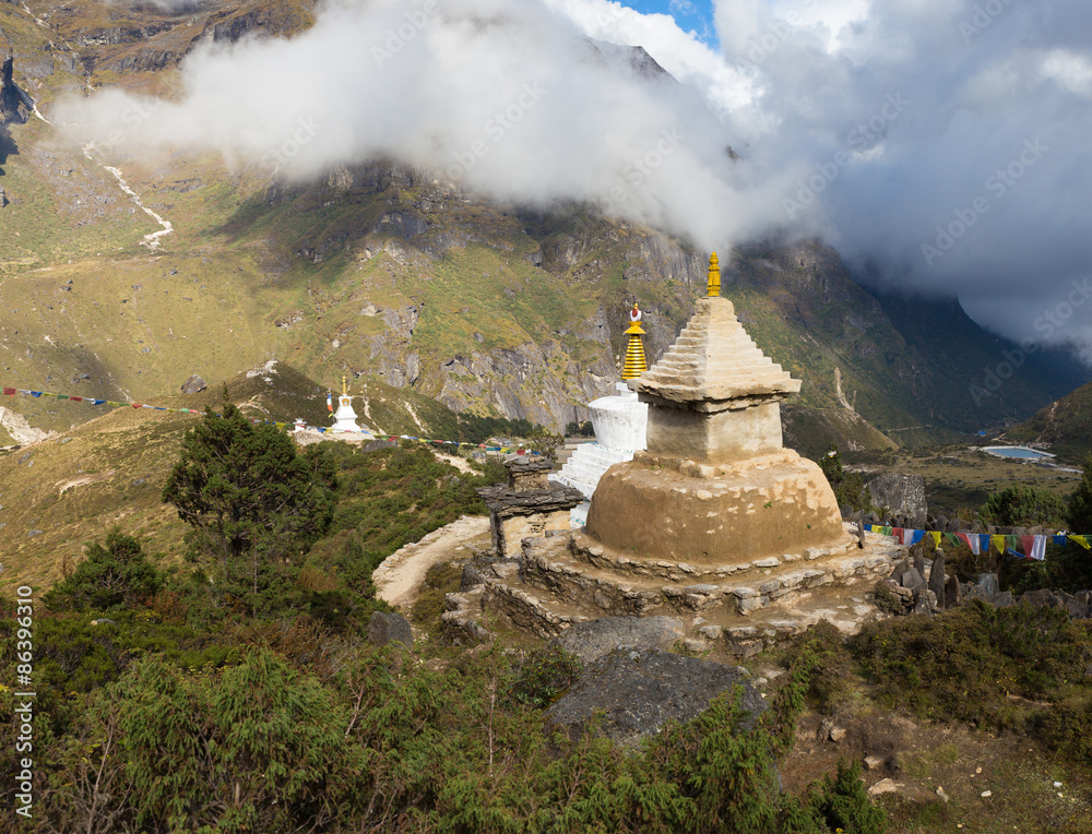 Buddhist stupa on mountain ridge.