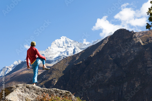 Man practicing yoga in Himalaya mountains.