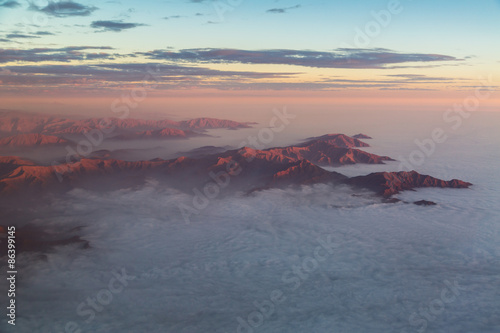 The Andes mountains rising out of a stratus cloudlayer