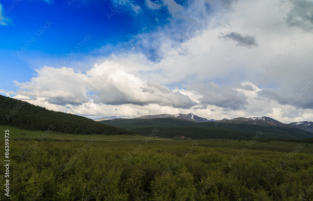 view of the mountains with a beautiful sky and clouds