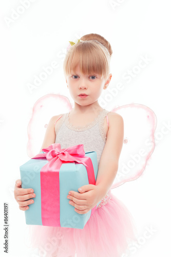 Pleasant little girl holding present 