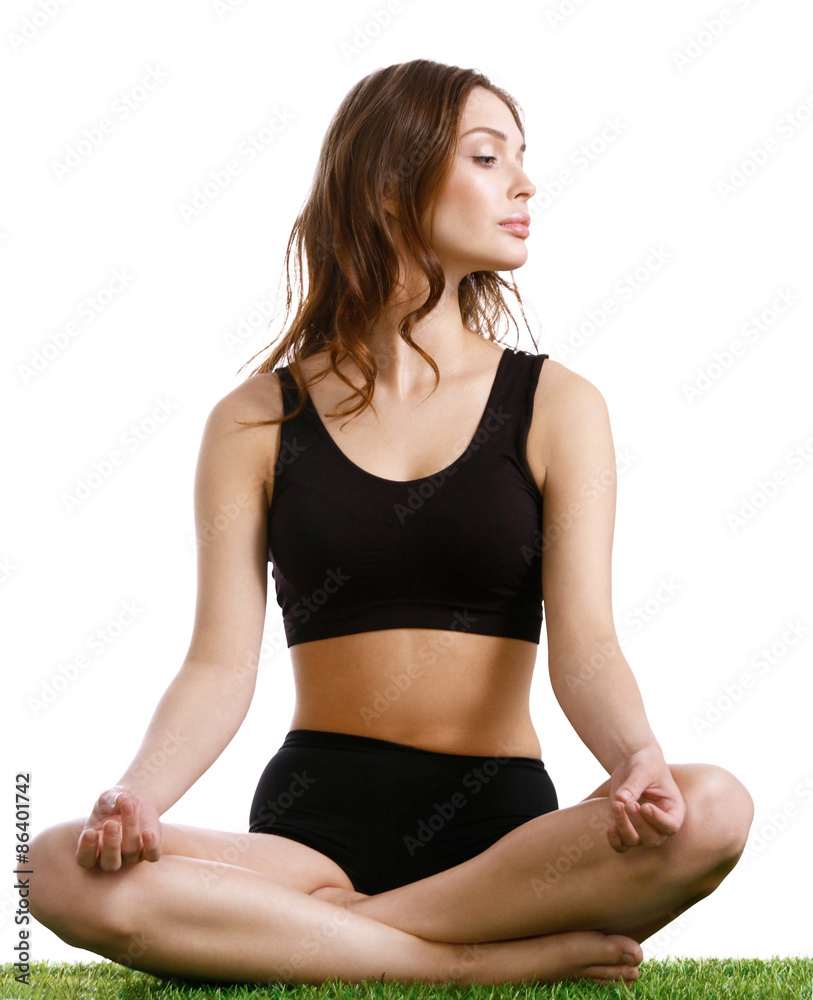 Young woman practicing yoga in the lotus position