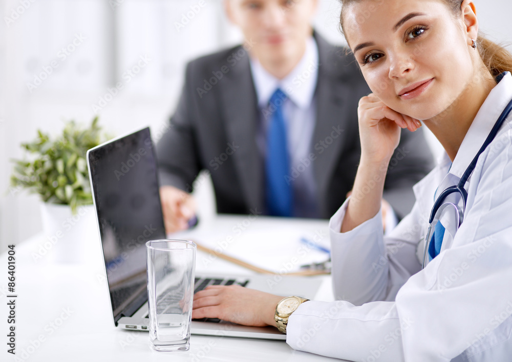 Medical team sitting at the table in modern hospital Medical team sitting at the table in modern hospital