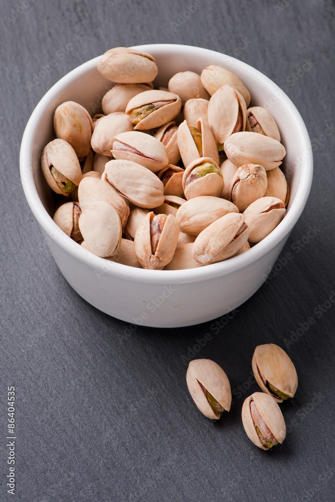 Diet healthcare concept. Roasted pistachio nuts seed with shell close up