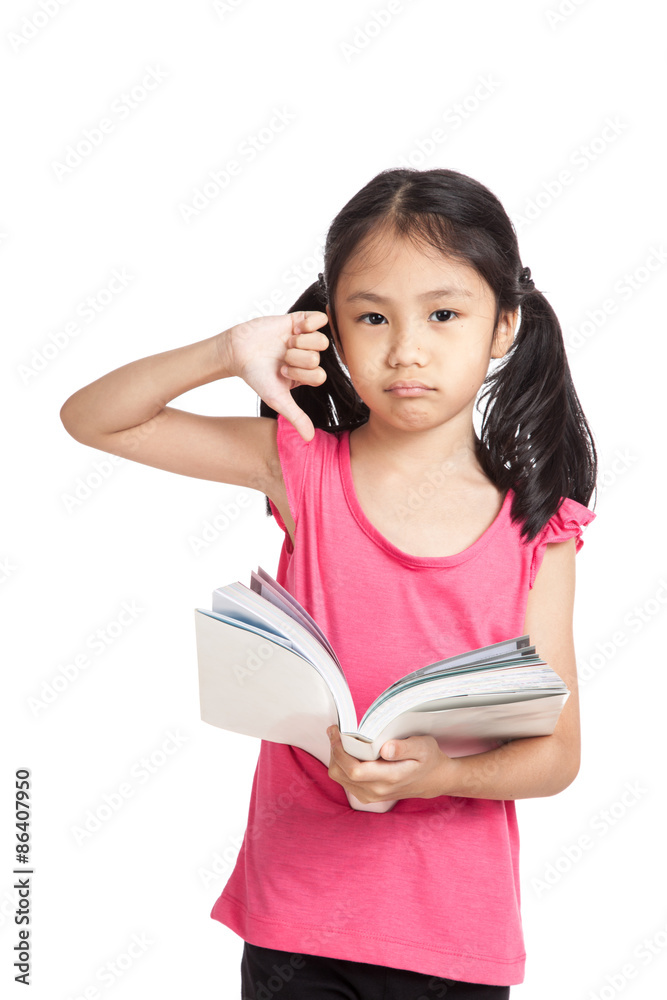 Little asian girl unhappy show thumbs down read a book Little asian girl unhappy show thumbs down read a book