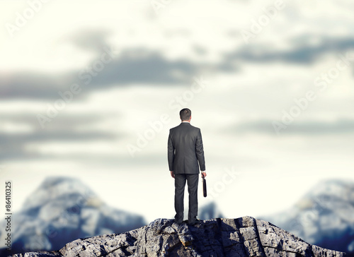 Businessman on mountain top
