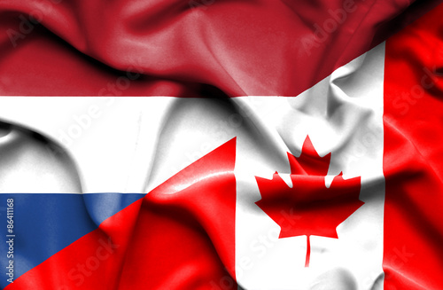 Waving flag of Canada and Netherlands