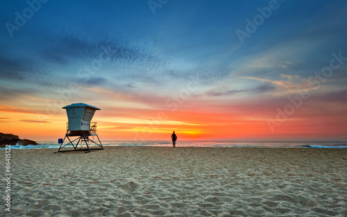 A surfer and lifeguard tower at Bronte rockpool with nice morning sky.