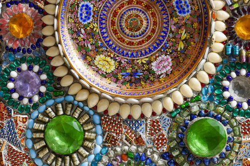 the colorful dish, bead and stone decorating on temple wall