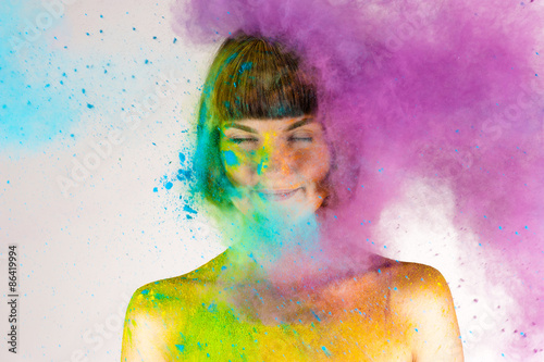 beautiful brunette girl in colors Holi on a white background