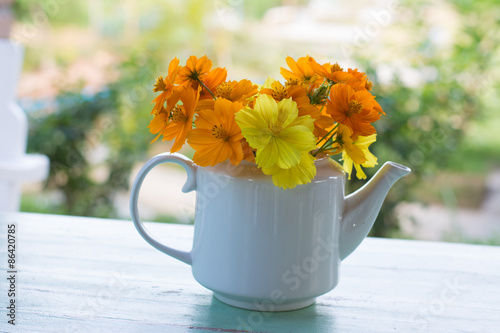 Wallpaper Mural Bunch of yellow garden cosmos flowers bouquet in vase on wooden table  Torontodigital.ca