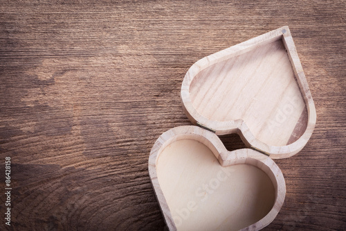 heart brown wood box on wood background, abstract love