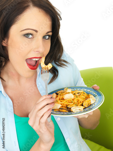 Young Woman In Her Twenties Holding a Plate of Seafood Pasta