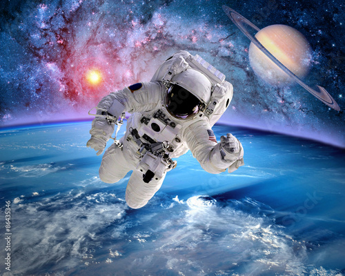 Fototapeta Naklejka Na Ścianę i Meble -  Astronaut spaceman outer space saturn planet earth sun. Elements of this image furnished by NASA.